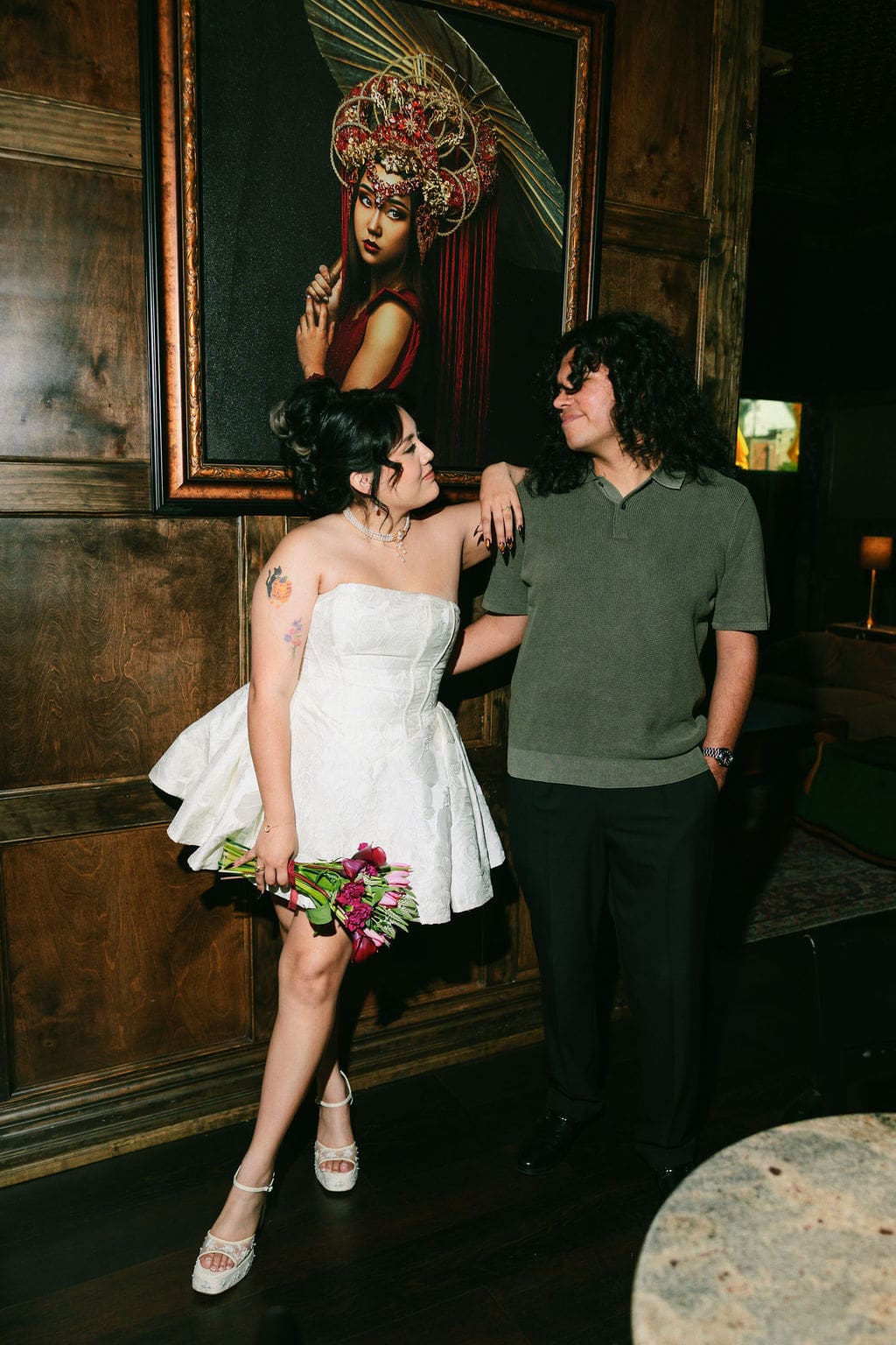 A couple in vintage style for an engagement session at Atlas Bar Fort Worth